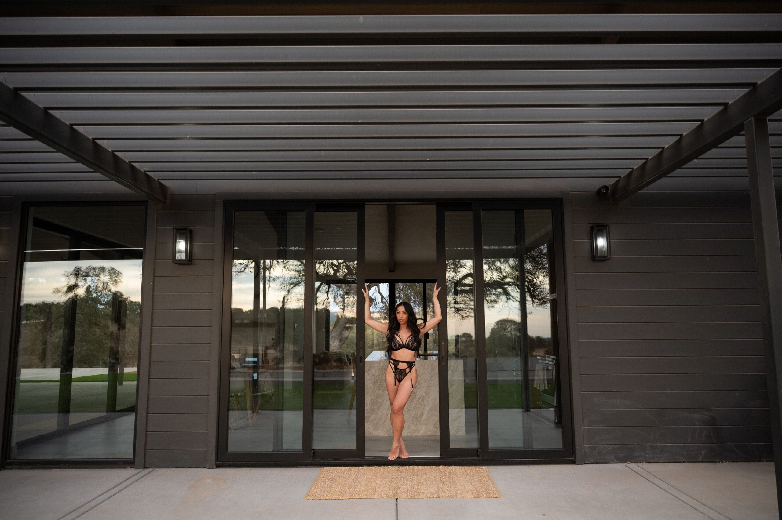 Woman posing outside a modern home during an El Dorado Hills boudoir session