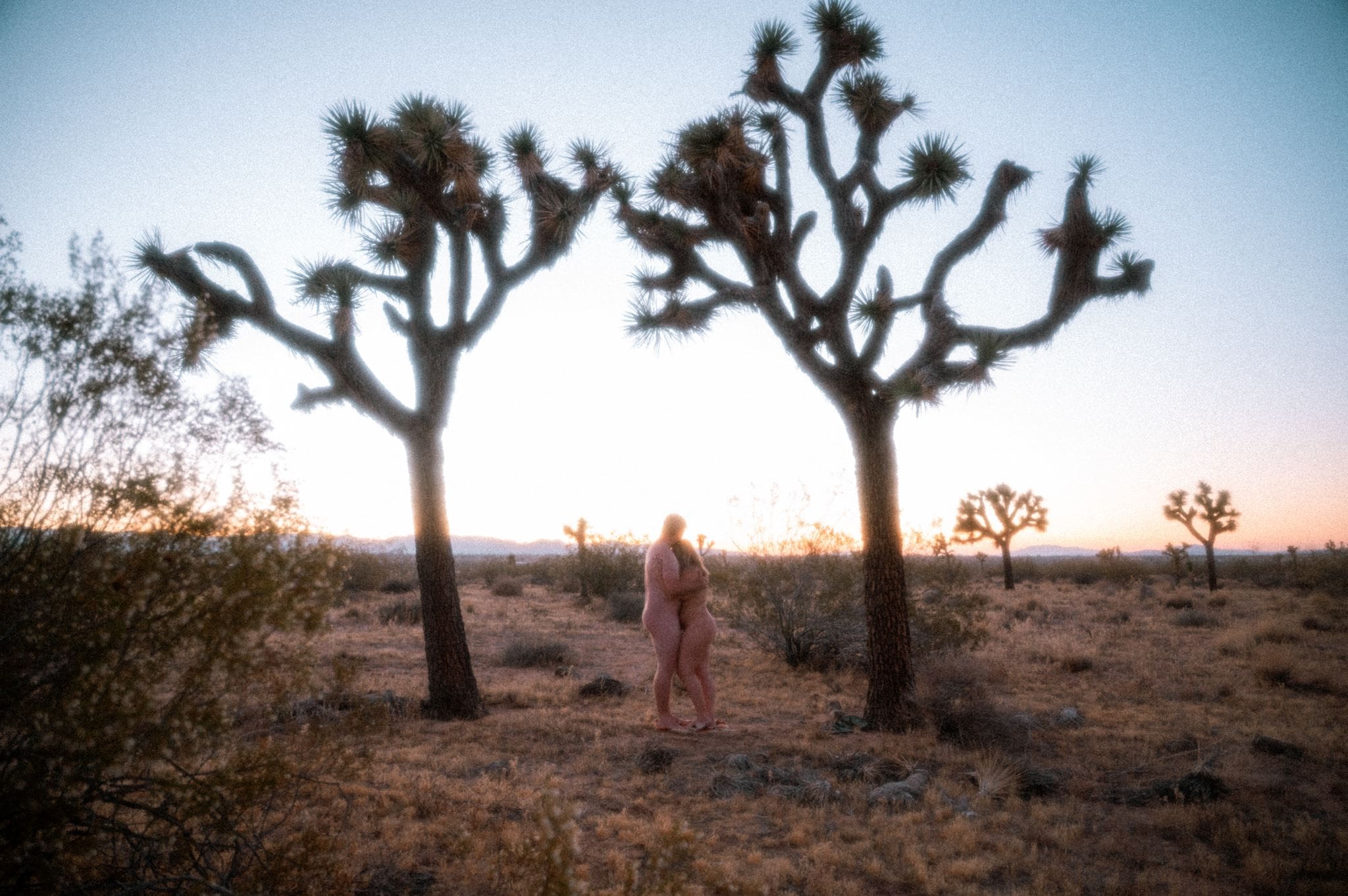 Couple celebrating intimacy and freedom at sunset